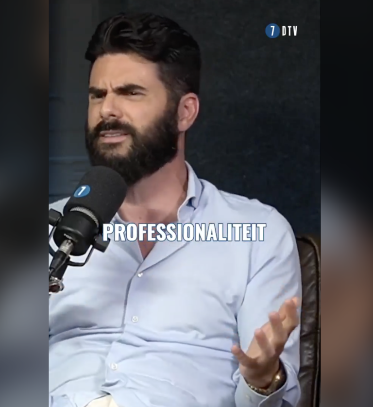 A bearded man in a light blue shirt sits speaking into a microphone with a logo on it. He gestures with his hands, and the text "PROFESSIONALITEIT" appears over the image. The background is dark, and there is a "7 DTV" logo at the top right.