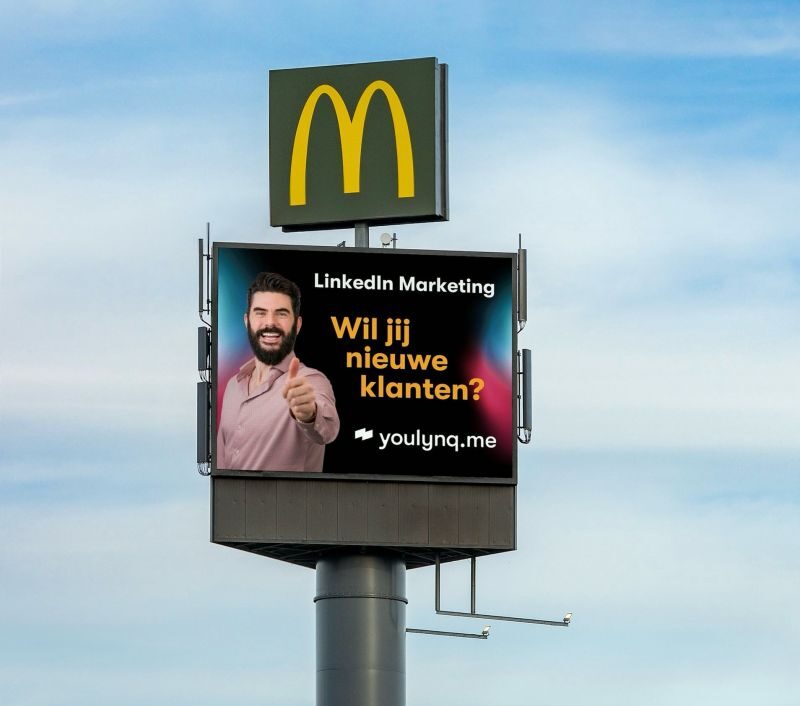 A roadside billboard below a McDonald's sign displays a LinkedIn Marketing advertisement. It features a man giving a thumbs-up and the text "Wil jij nieuwe klanten?", with the website "youlynq.me" at the bottom. A blurred truck is visible passing by.